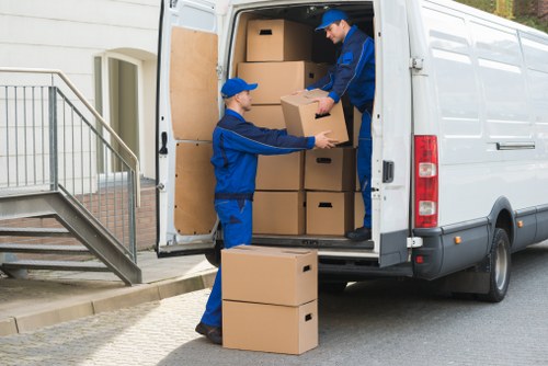 Movers handling flat removals in Chessington outside an apartment building
