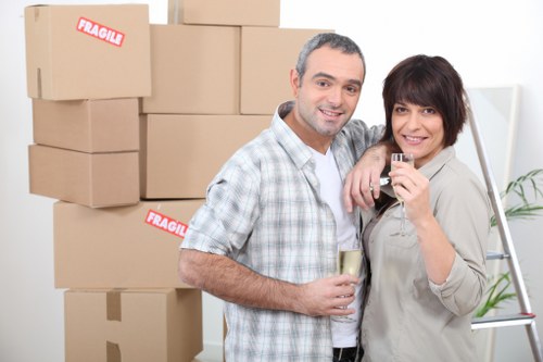 Mover carrying a boxed item carefully through a doorway